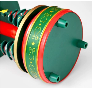 Macro view of a festive Christmas music box base with gold star patterns and green feet
