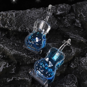 Violin shaped glowing sand ornaments with deep blue liquid and silver star glitters