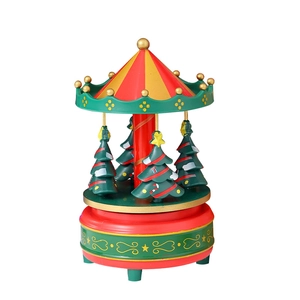 Christmas carousel music box with rotating green trees in red and gold festive design