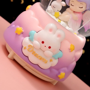 Snow globe music box with rabbit and stars in pastel pink and purple colors