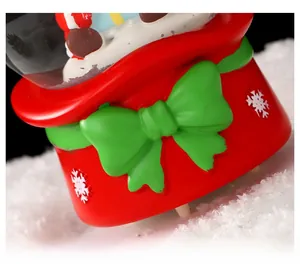 Detailed view of festive red Christmas ornament with green bow and white snowflake patterns