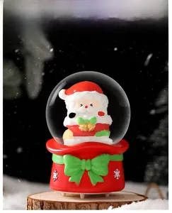 Detail of Santa Claus glowing crystal ball ornament on wood with festive snowy background