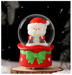 Detail of Christmas crystal ball with Santa Claus inside on a red bag-shaped base