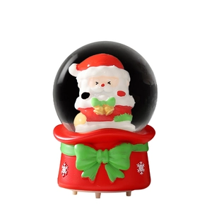 Luminous Christmas crystal ball with Santa Claus figurine and festive red ribbon base