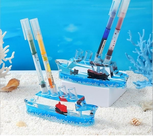 Creative Titanic liquid drift pen holder on beach sand with sea shells and blue sky