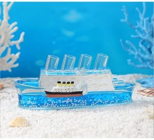 Detailed close-up of floating Titanic ship and iceberg in blue liquid motion ornament