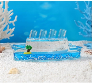 Detail of creative cruise ship fluid paperweight with blue liquid and miniature palm trees