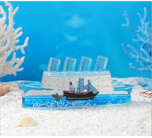 Detail view of cruise ship fluid drift bottle with pirate ship and shark in blue liquid