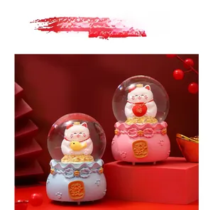 Detail of blue and pink lucky cat crystal balls with Chinese fortune character base