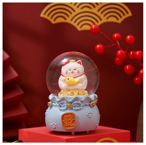 Macro shot of festive Fortune Cat crystal ball on blue lucky bag base with Fa character