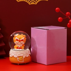 Festive Chinese New Year Fortune Cat crystal ball with gift box on red holiday backdrop