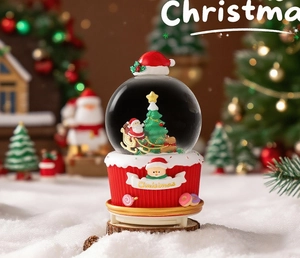 Close-up of a Santa Claus snow globe with a red cupcake base and festive Christmas decorations