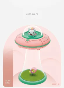 Macro detail of a cute pink unicorn night light inside a UFO glass dome with grass base