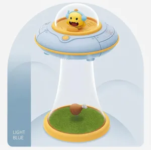 UFO night light detail showing a yellow dragon inside a blue saucer with green grass base