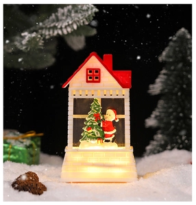 Detailed Christmas LED cottage lamp with miniature Santa and warm festive light