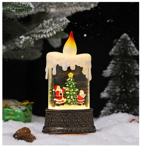 Macro shot of LED Christmas candle lantern featuring a miniature Santa and snowy base