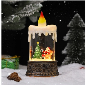 Close-up of a lit Christmas snow globe lantern with Santa Claus and a vintage bronze base