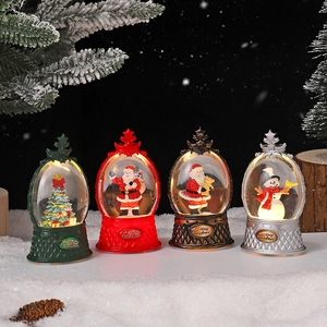 Four festive Christmas LED lanterns with snow globe scenes and Merry Christmas base