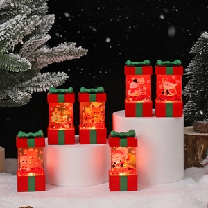 Set of 6 Christmas light-up gift box lamps with Santa and Snowman scenes on display stands
