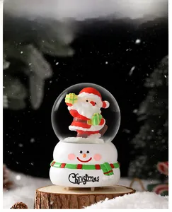 Détail de la boule de cristal de Noël avec Père Noël sur socle en bois rustique