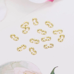 Macro shot of 14k gold-plated dragon S-shape jewelry connectors for DIY bracelet making