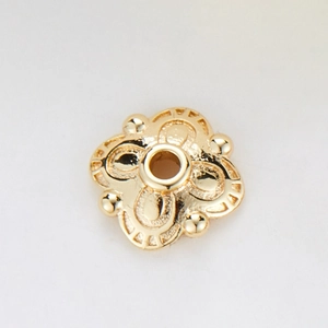 Macro detail of 14k gold plated copper flower spacer bead with zircon hollow petal design
