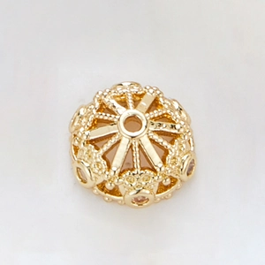 Close-up of 14k gold-plated hollow petal spacer bead cap with detailed metal texture