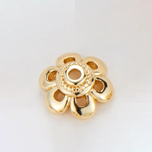 Macro shot of 14k gold-plated flower bead cap with hollow petals for DIY jewelry