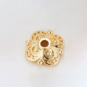 Detail showing 14k gold plated four-petal flower bead cap with centered hole for DIY jewelry