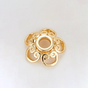 Macro view of 14k gold-plated flower spacer bead with spiral texture for jewelry making