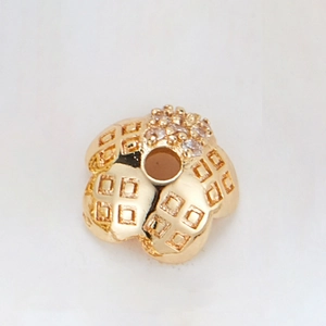 Detailed view of gold plated flower bead spacer with zircon inlay for jewelry making