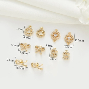 Detailed macro view showing 14k gold shell charms with precise size measurements in mm