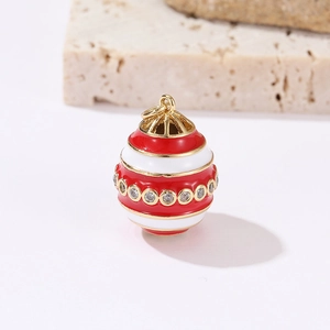 Detail showing red and white enamel egg pendant with gold trim and sparkling zircons