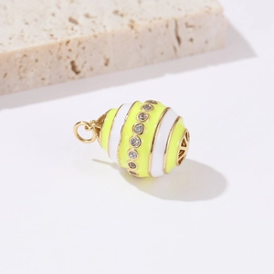 Close-up of a 14k gold-plated egg pendant with yellow enamel and micro-set cubic zirconia