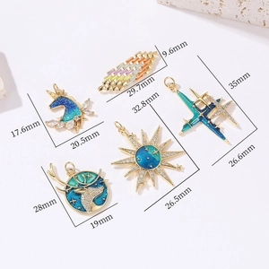 Detail of gold enamel pendants featuring unicorn and star motifs with size markings