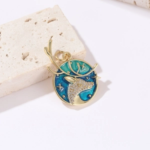 Macro shot of gold moose elk pendant with blue enamel sky and micro zircon stones