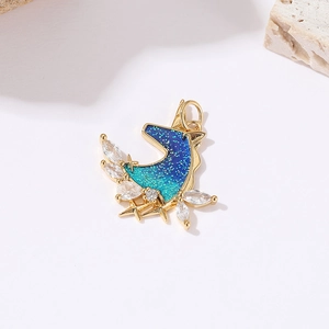 Detail of moon pendant with blue-green starry sky enamel and sparkling zircons