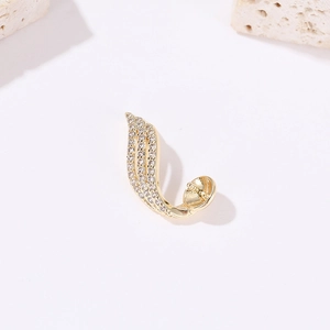 Macro detail of gold plated laurel leaf earring featuring micro-pave cubic zirconia stones