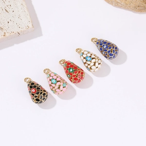 Evil eye oval enamel pendants in five colors on a textured stone background