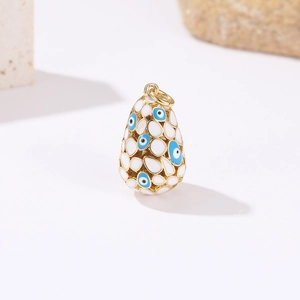 Detailed view of oval evil eye pendant with 14k gold plating and blue enamel details