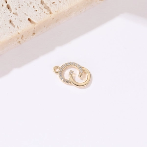 Macro shot of 14k gold interlocking double ring pendant with pavé cubic zirconia