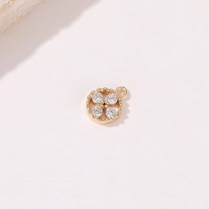 Detailansicht eines vergoldeten Blumenanhängers mit vier Zirkonia für DIY-Schmuck