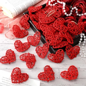 Handmade red wicker heart ornament for wedding decor on a light wood background