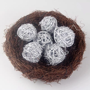 Silver woven rattan balls in decorative brown twig bird nest for Christmas shop window display
