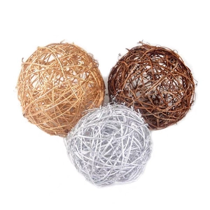 Three decorative rattan balls in gold, brown, and silver colors for Christmas decor