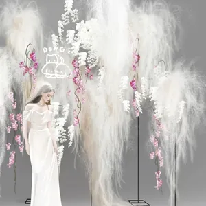 Wedding background decor with white faux pampas grass and hanging pink floral accents