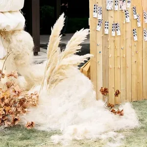 Natural cream raffia and dried reed flower arrangement for wedding scene decoration