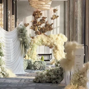 Creamy wedding venue decor with gypsophila floral clouds and elegant fabric backdrop