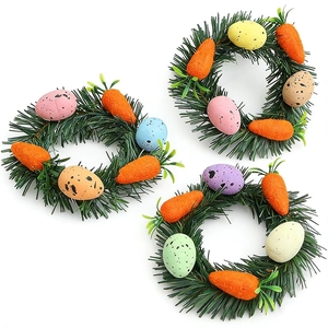 Easter mini wreaths with colorful eggs, orange carrots and green pine needles on white background
