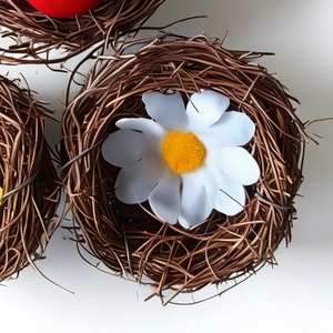 Handwoven Easter rattan bird nest with daisy flower decoration for holiday scene layout